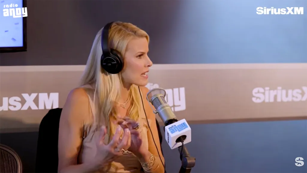 Beth Stern speaking into a microphone while wearing headphones in a SiriusXM studio.
