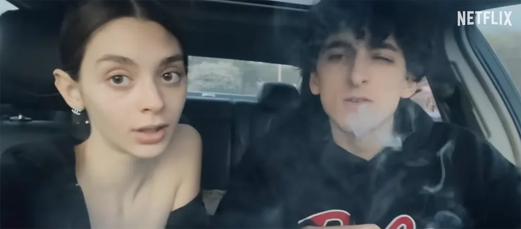 A man smoking a cigarette and a woman in a car, from the Netflix trailer for 