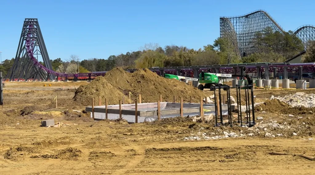 Six Flags roller coaster construction with purple track.