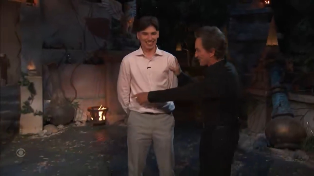 Jeff Probst pointing at a man in a pink shirt.