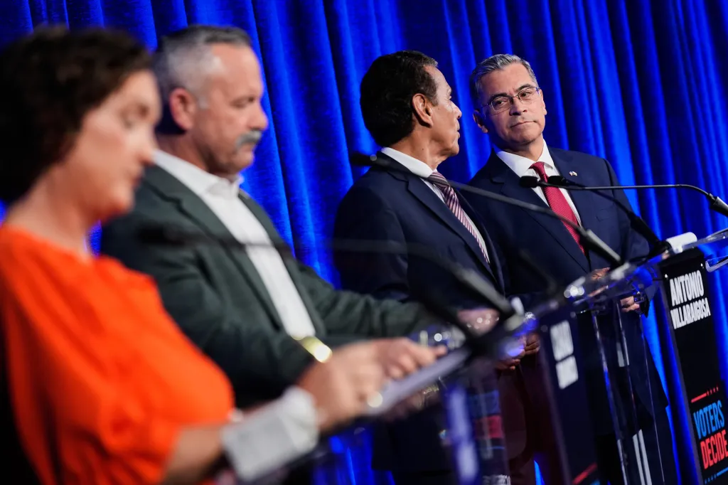 Xavier Becerra listens to Antonio Villaraigosa during a California gubernatorial debate.