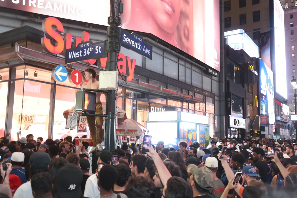 Knicks fans celebrate on 34th Street and 7th Avenue near Madison Square Garden after the team won Game 1 of the NBA finals.