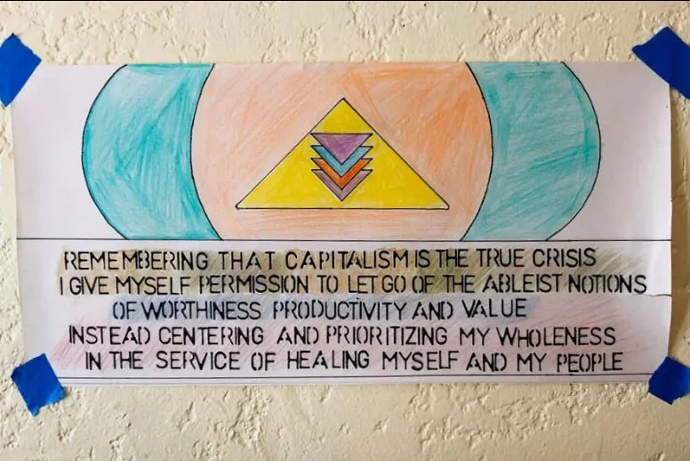 A hand-drawn sign taped to a wall reads, 