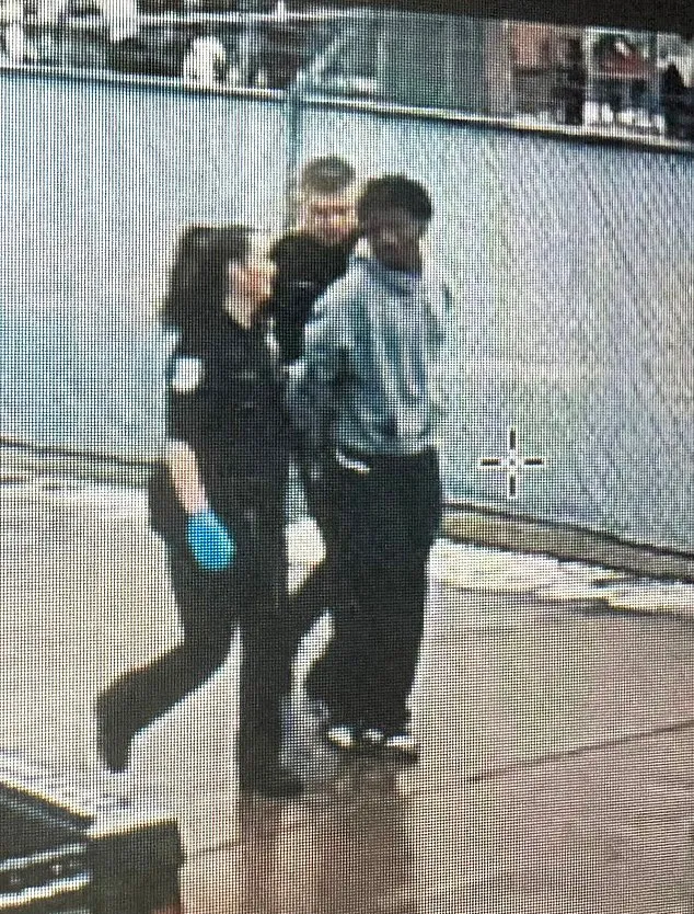 Anthony being arrested by a police officer and another person at a track meet.
