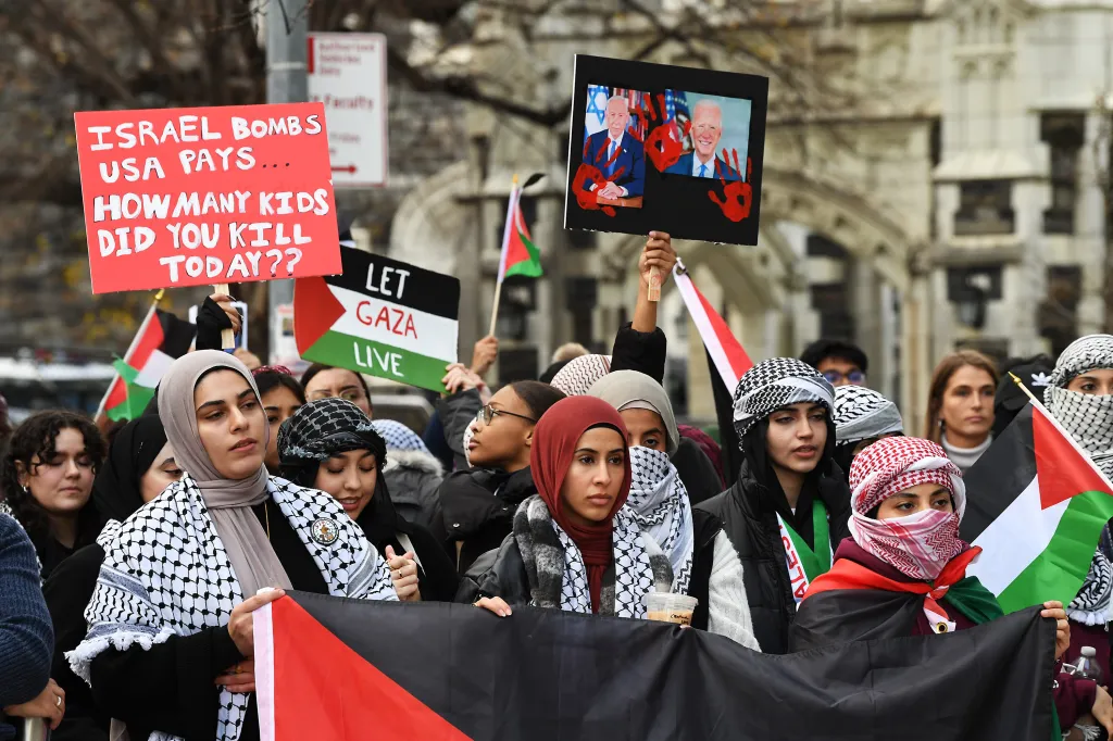 People protesting in support of Palestine, holding signs that read 