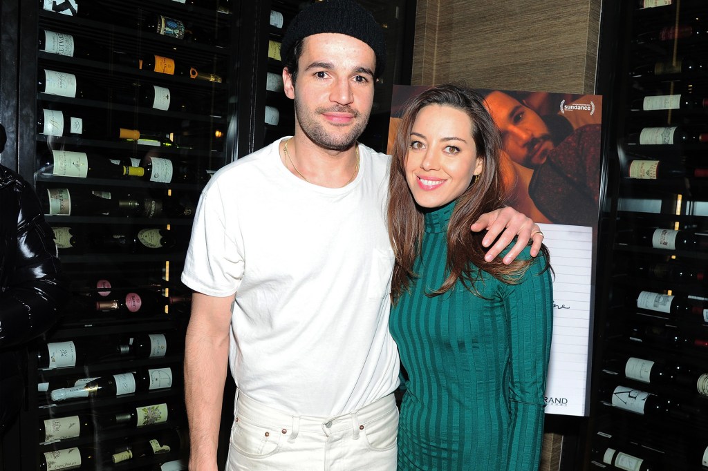 Aubrey Plaza and Jeff Baena pose for a photo in a wine cellar.