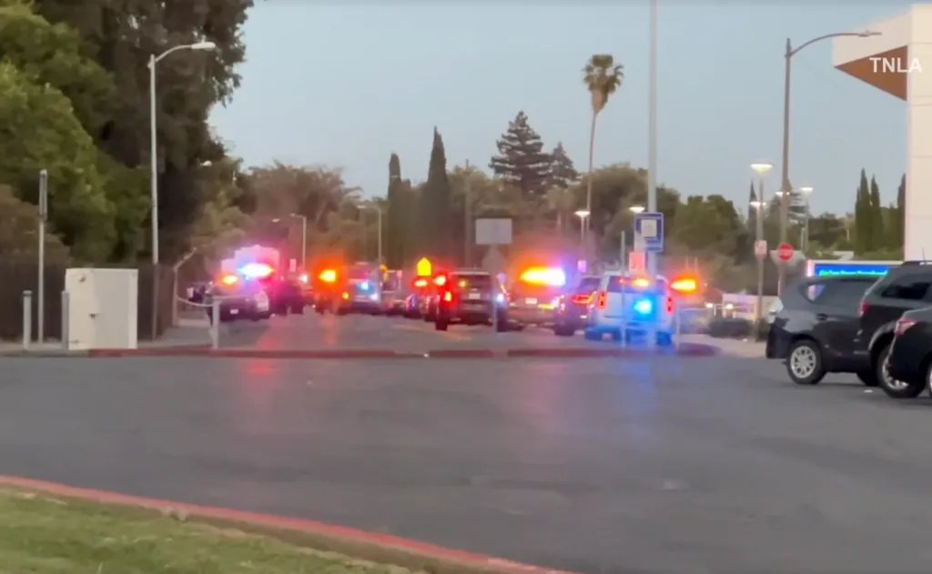 Several police vehicles with flashing lights at a nighttime incident.