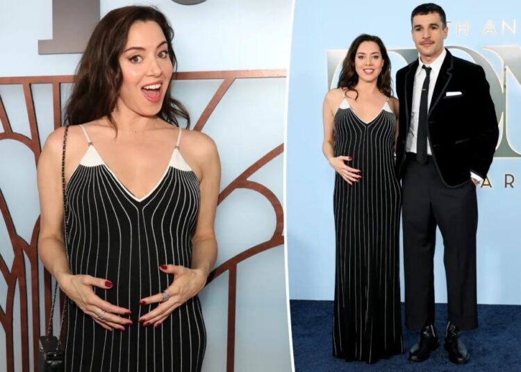 Aubrey Plaza cradles her baby bump while supporting partner Chris Abbott at Tony Awards 2026
