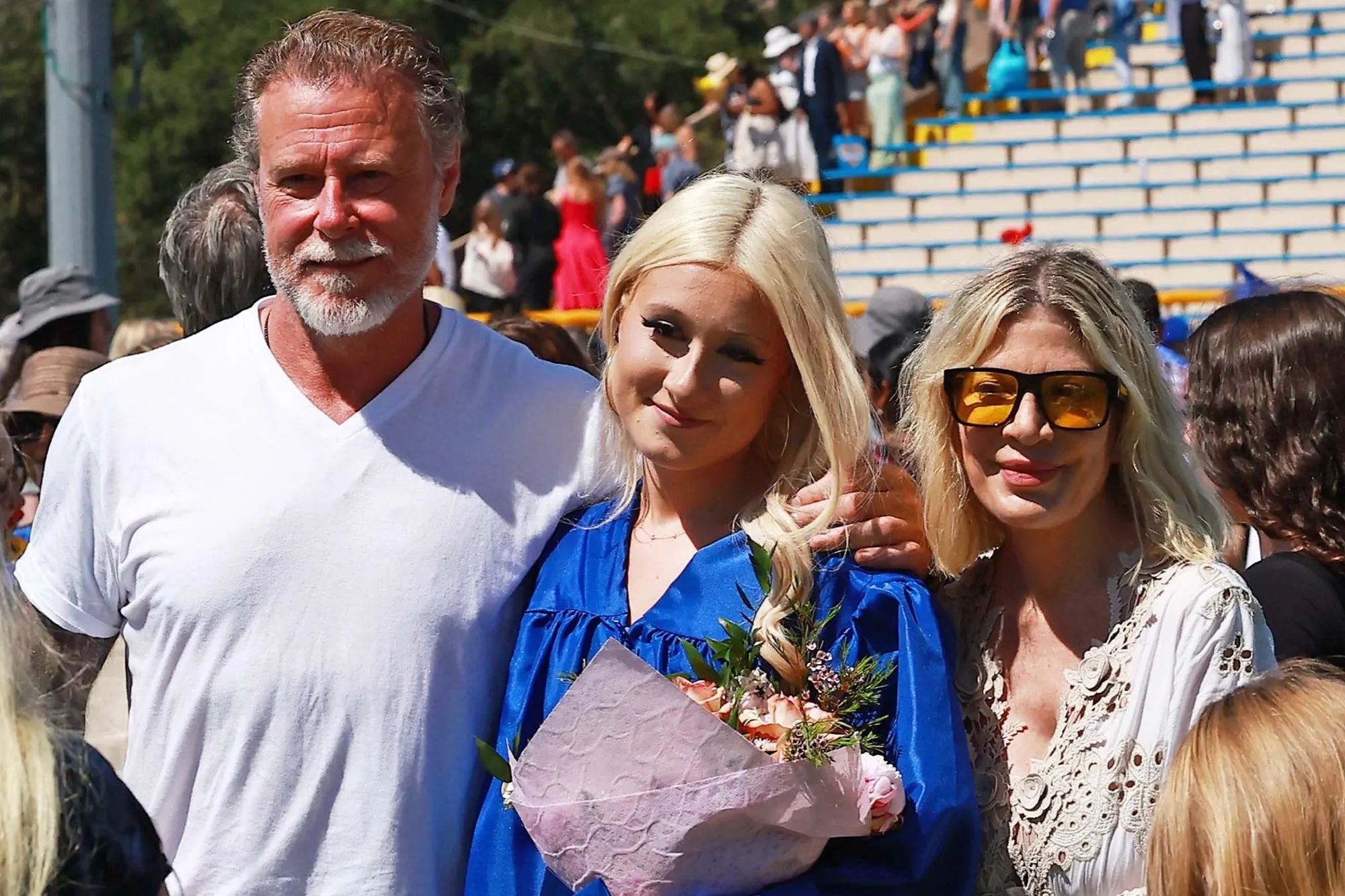 Tori Spelling, Dean McDermott, and daughter Stella at Stella's graduation.