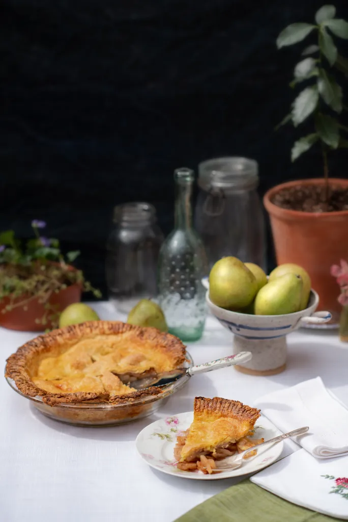 A pie and a bowl of pears