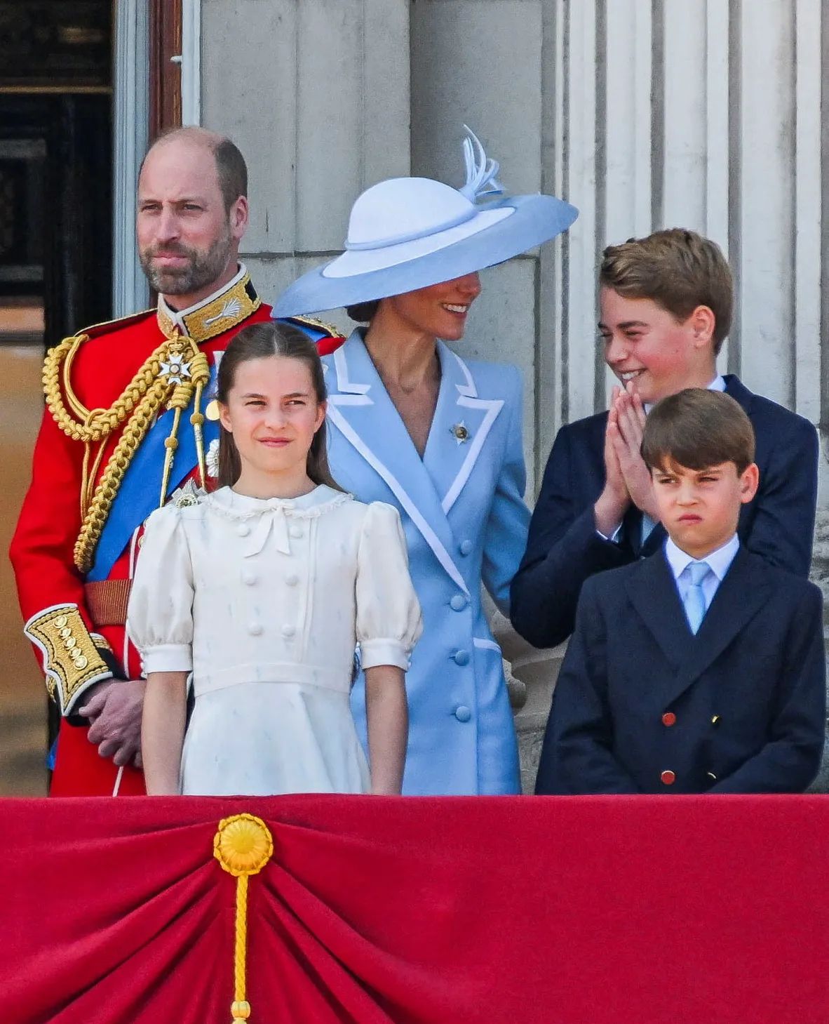 Prince William, Kate Middleton, Princess Charlotte, Prince George, and Prince Louis on a balcony.