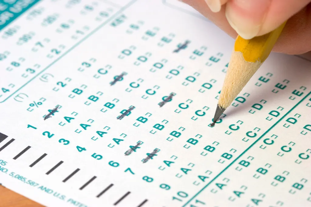 A yellow pencil filling in answers on a Scantron test.