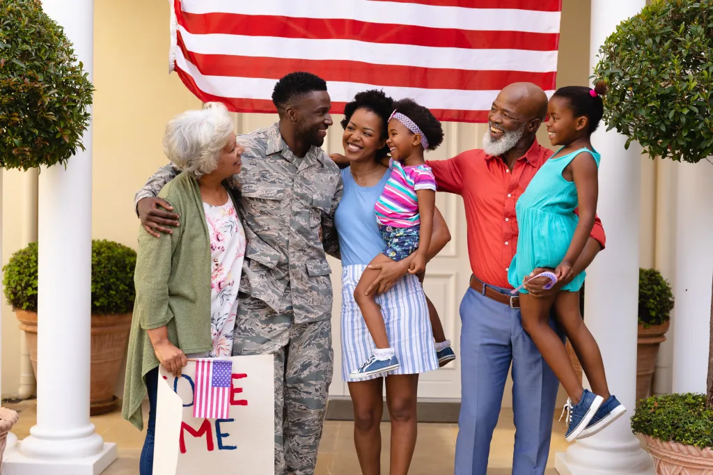 A cheerful African American family with a soldier and a