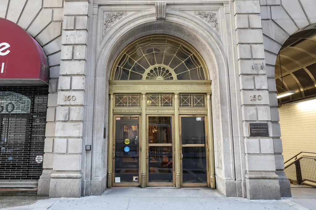 Exterior of 150 William Street in Manhattan, home to the Administration for Children's Services, featuring a gold arched entrance and a red awning.