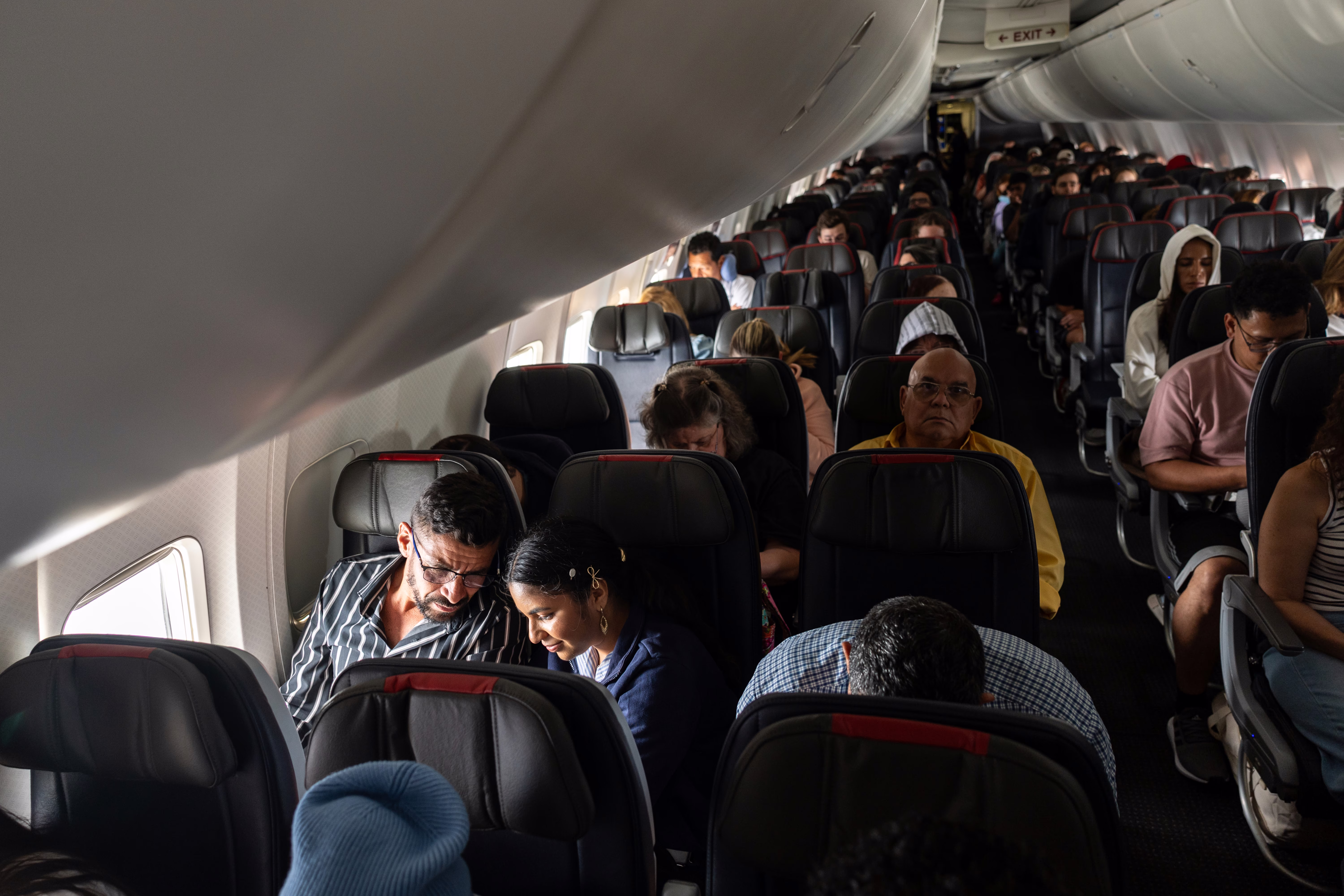 People seated inside a passenger aircraft