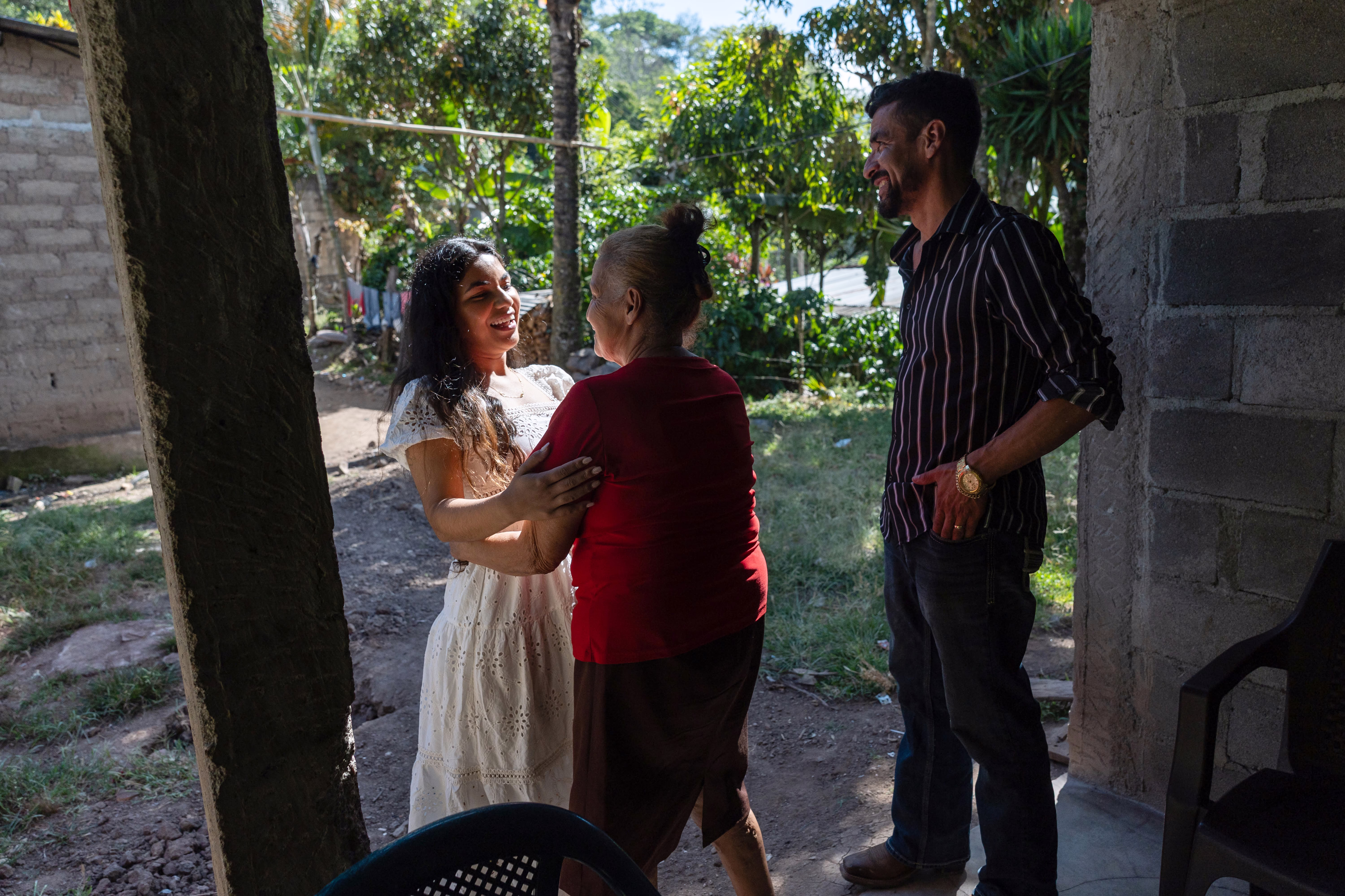 Family members greet each other in a courtyard.