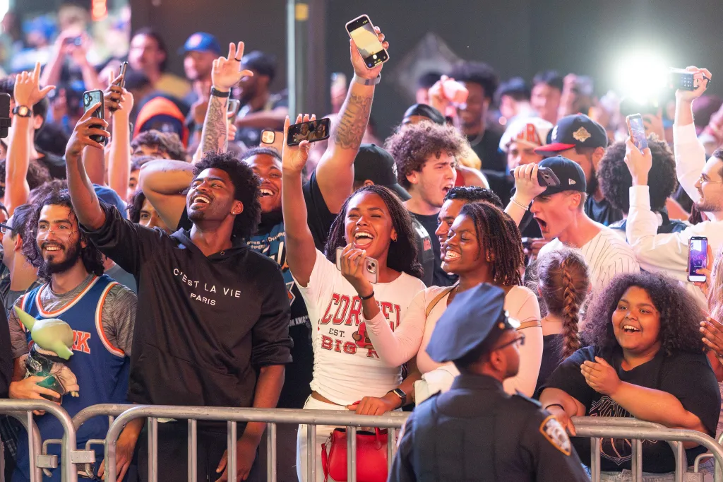 New York Knicks fans reacting while watching the NBA Finals outside Madison Square Garden.