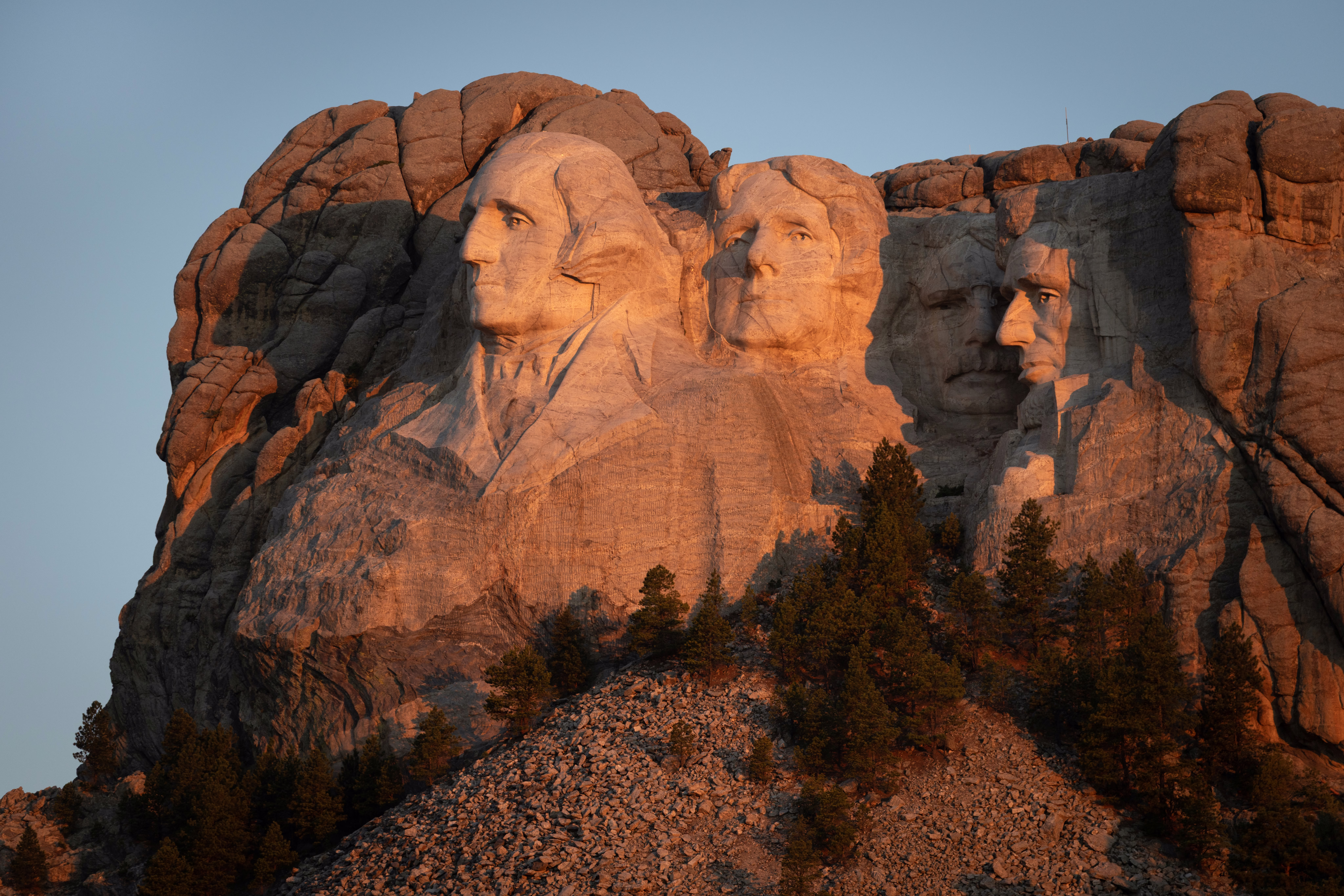 The sun rises over Mount Rushmore National Monument.