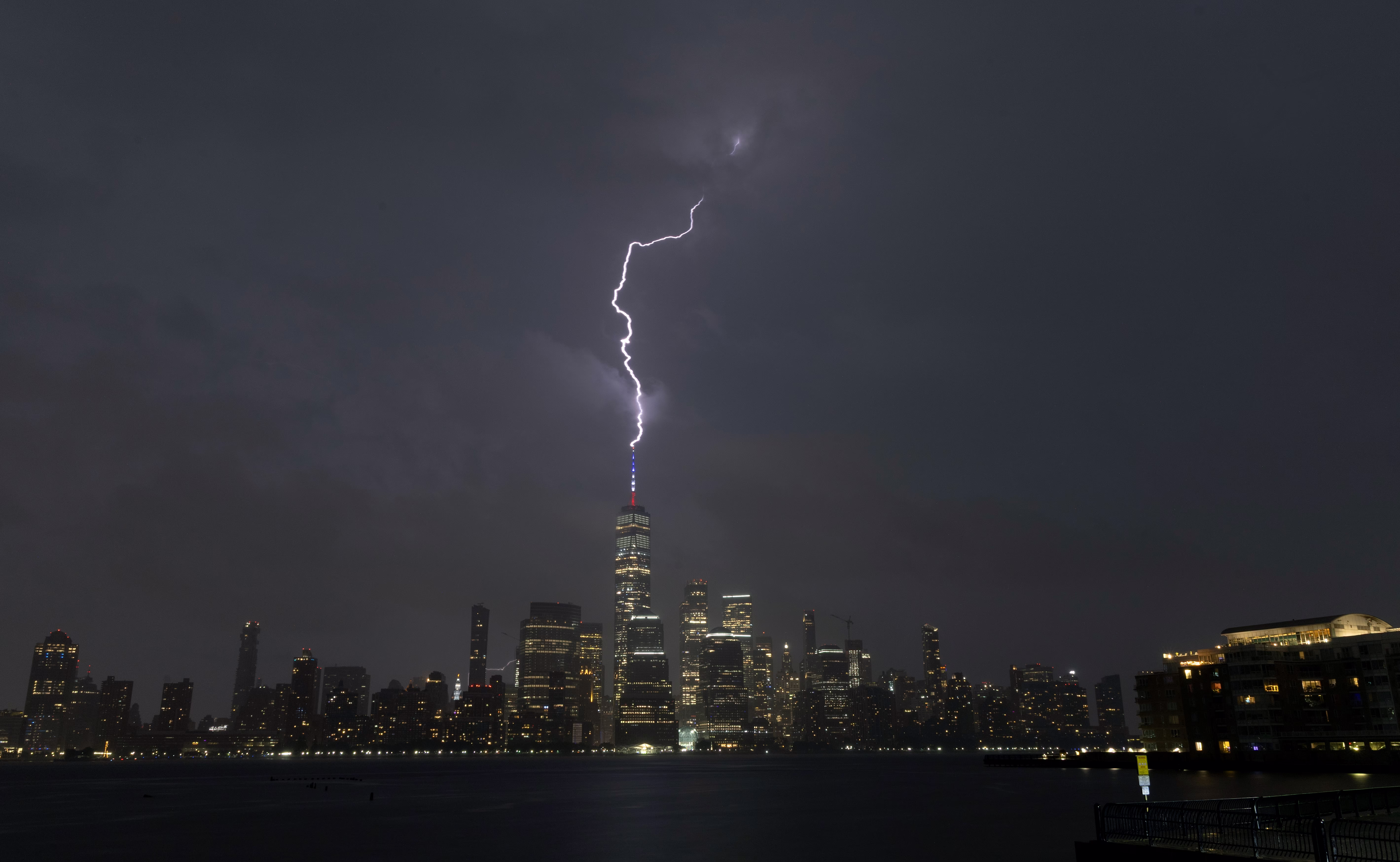 A lightning bolt strikes One World Trade Center during a thunderstorm in New York City.