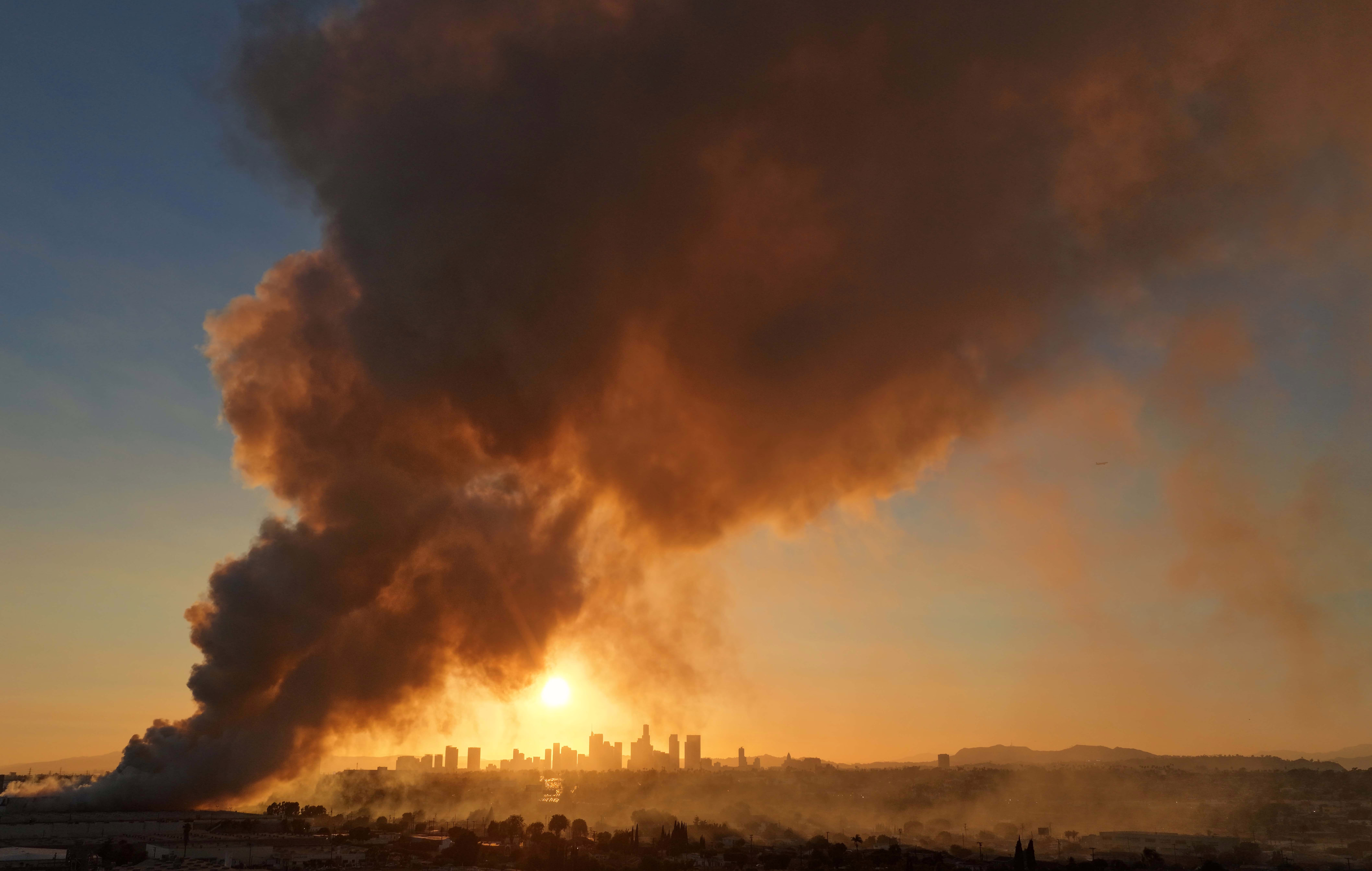 An aerial view of smoke from a warehouse fire rising above Los Angeles.