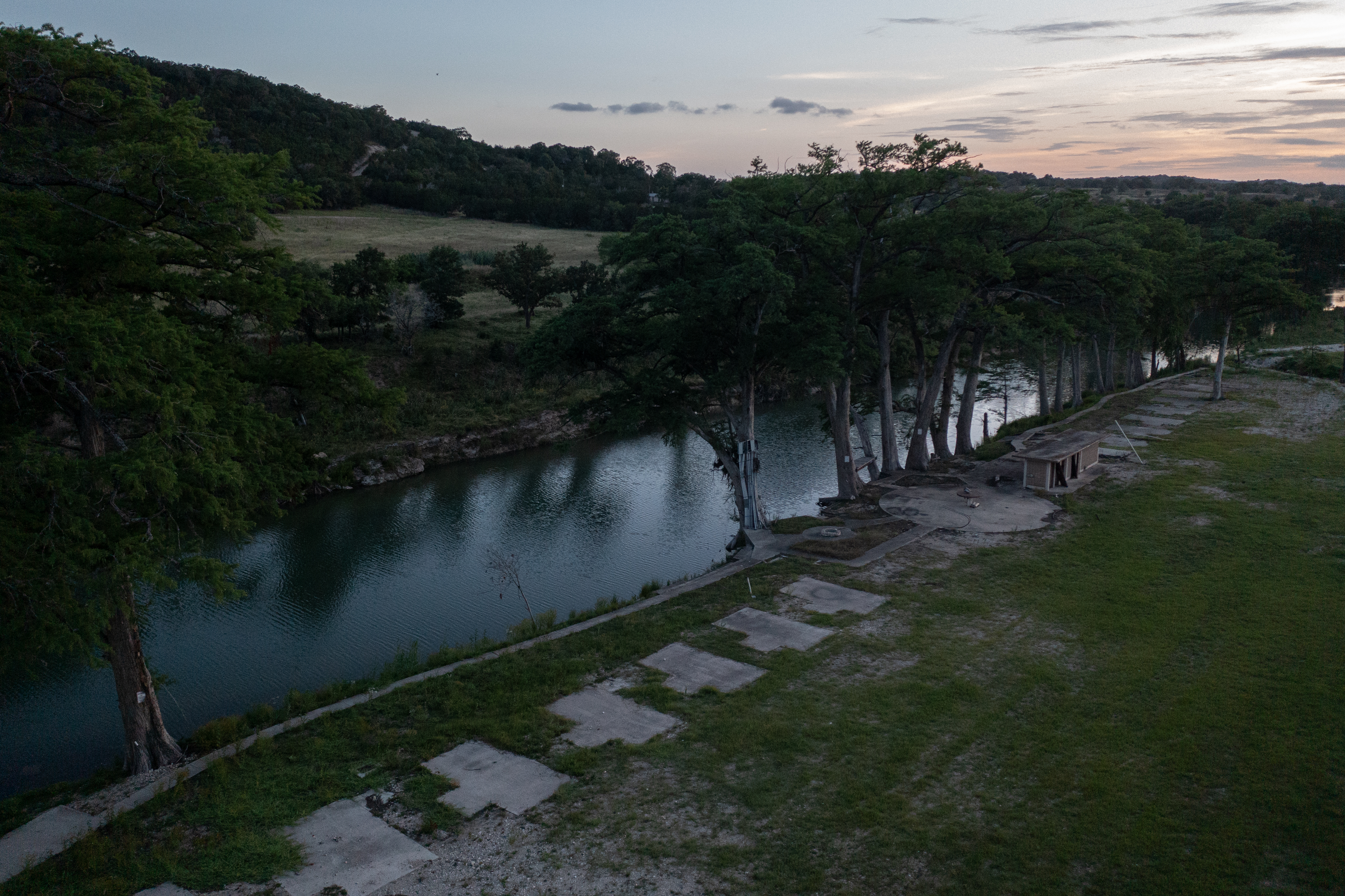 Empty concrete RV pads along a riverbank in Texas