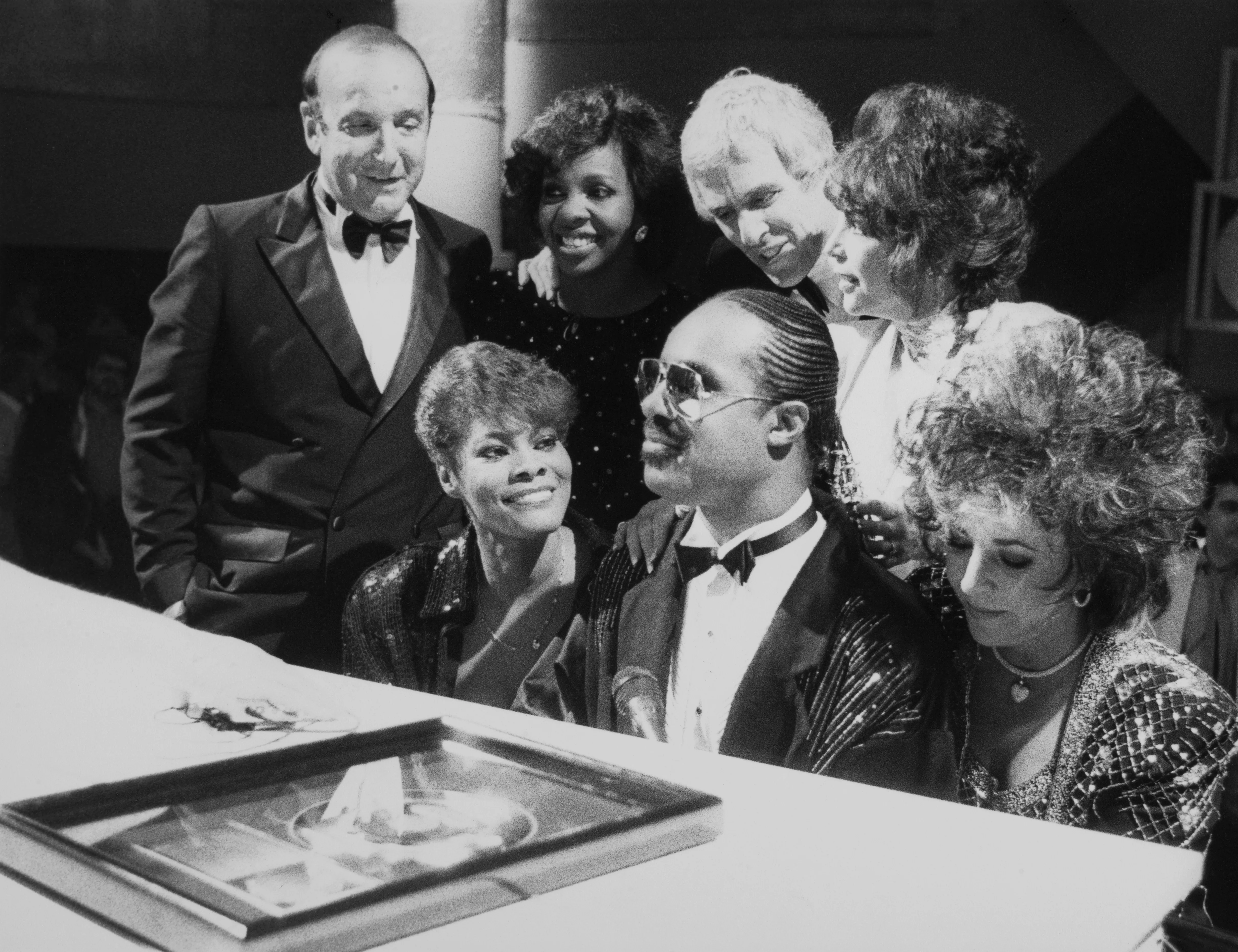 Clive Davis, Dionne Warwick, Stevie Wonder, Elizabeth Taylor, Gladys Knight, Burt Bacharach, and Carole Bayer Sager at a 