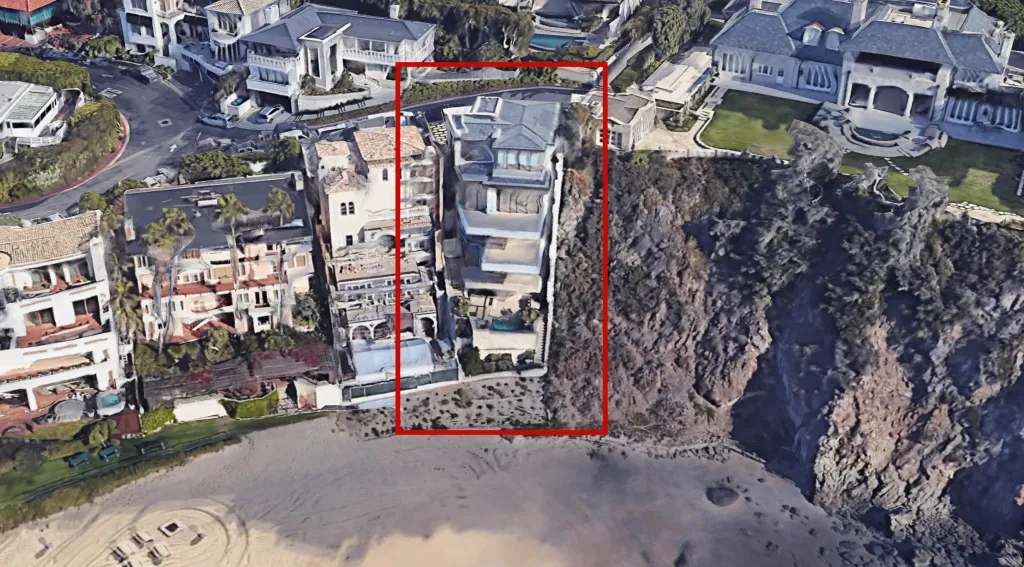 Aerial view of 20 Emerald Bay, Laguna, from Google Earth, highlighted in a red box, situated on a cliff overlooking a beach.