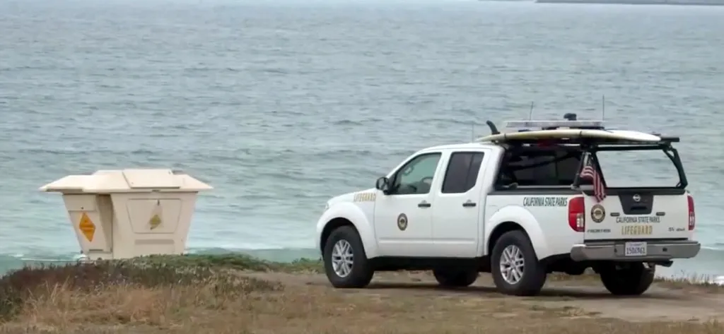 California State Parks lifeguard pickup truck parked next to the ocean.