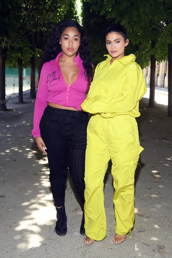 Jordyn Woods and Kylie Jenner posing in activewear at Louis Vuitton Menswear Spring/Summer 2019 show.