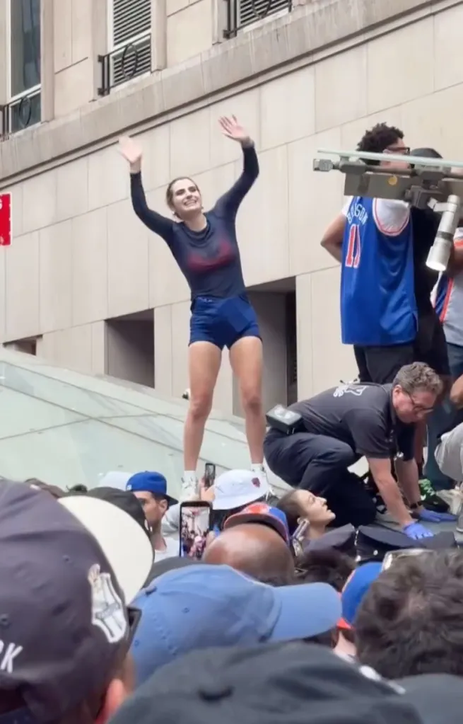 Simone Kelly waves after rescuing the man on top of the subway station entrance.