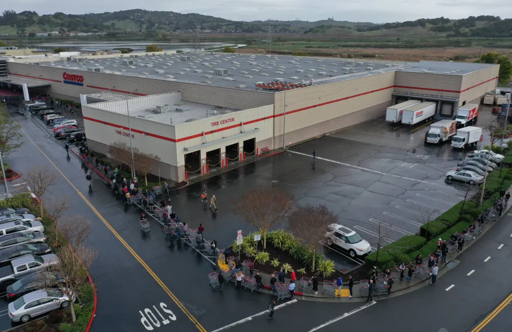 Aerial view of customers waiting in a long line outside a Costco store in Novato, California.