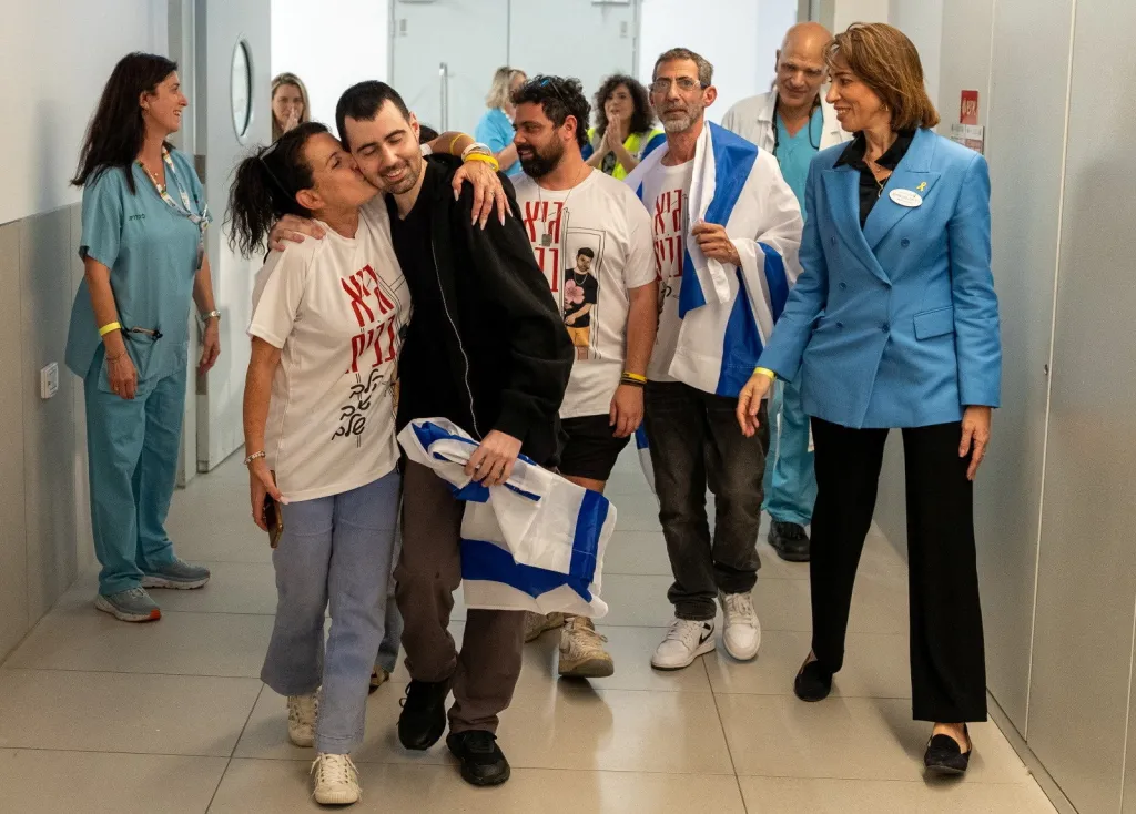 A loved one kisses released Israeli hostage, Guy Gilboa-Dalal, at Rabin Medical Center.