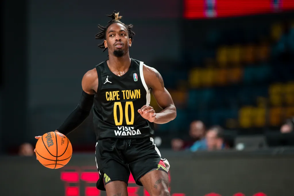 Zaire Wade dribbles the ball during a basketball game.