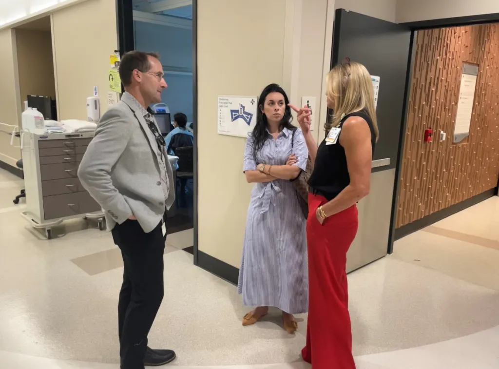 Yardena Wolf of Congressman Eric Swalwell's office, with two people, touring the Eden Medical Center.