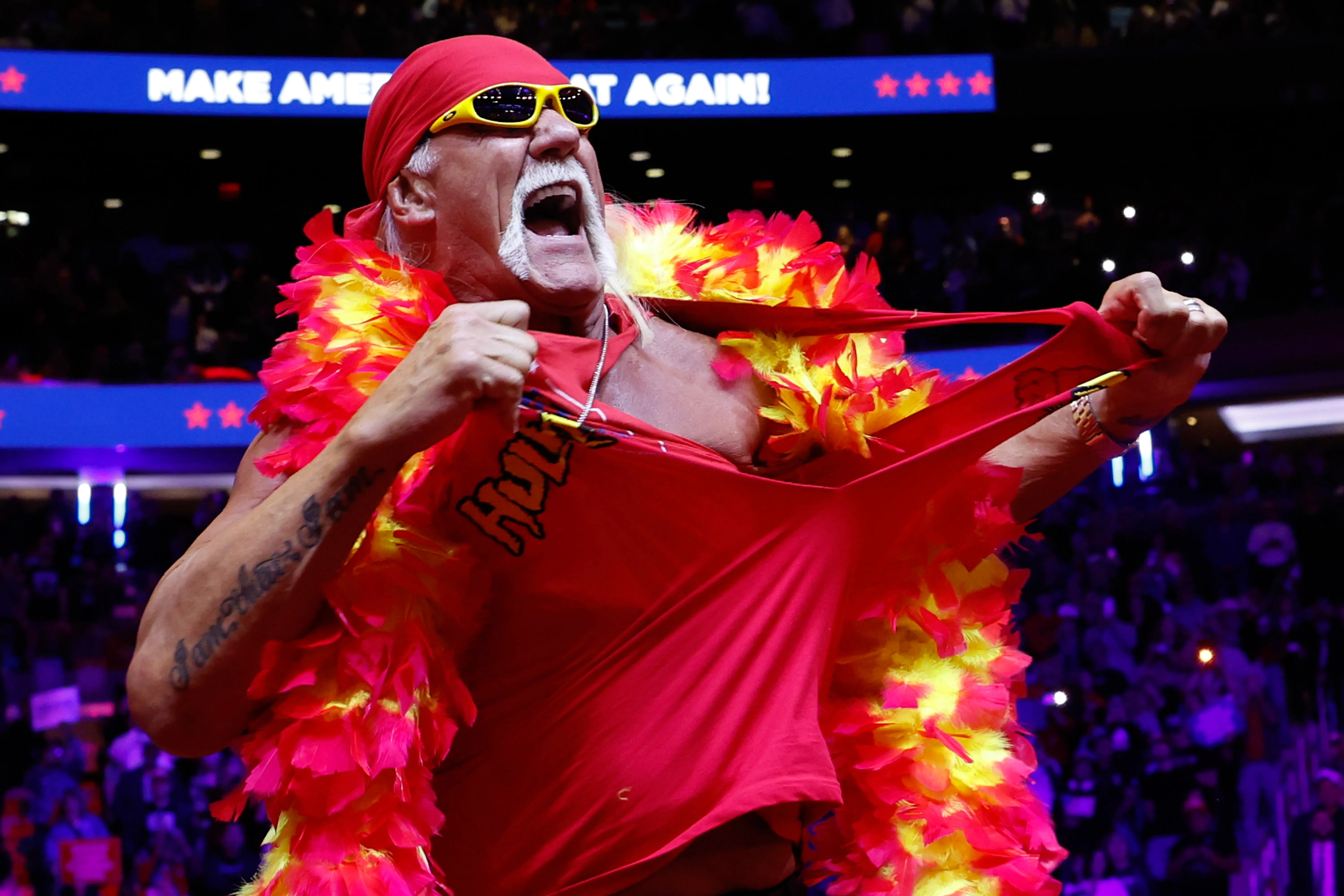 Hulk Hogan ripping his shirt off on stage at a Trump rally.