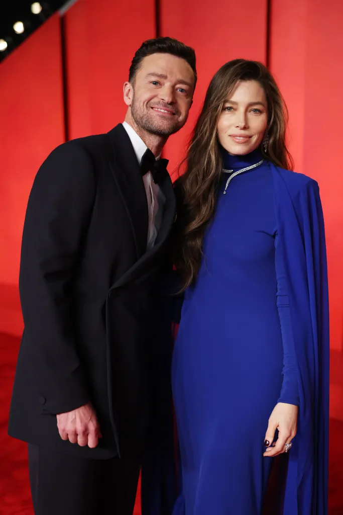 Justin Timberlake in a black tuxedo and Jessica Biel in a royal blue gown and diamond necklace attend the Vanity Fair Oscar Party.