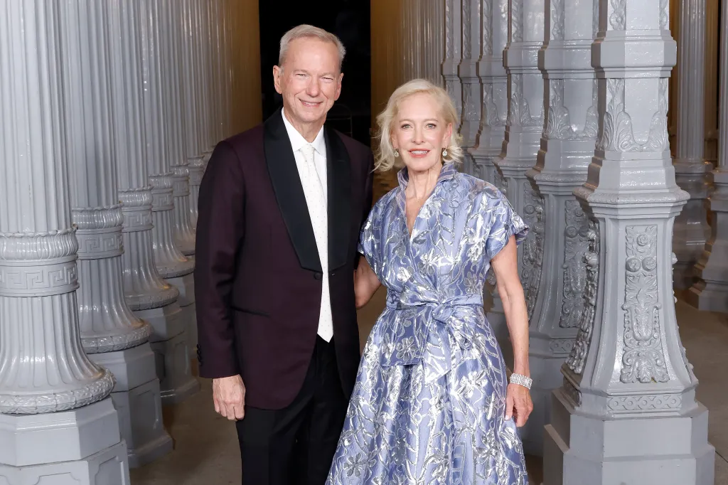 Eric Schmidt in a burgundy tuxedo and Wendy Schmidt in a metallic blue dress attend the 2025 LACMA Art+Film Gala.