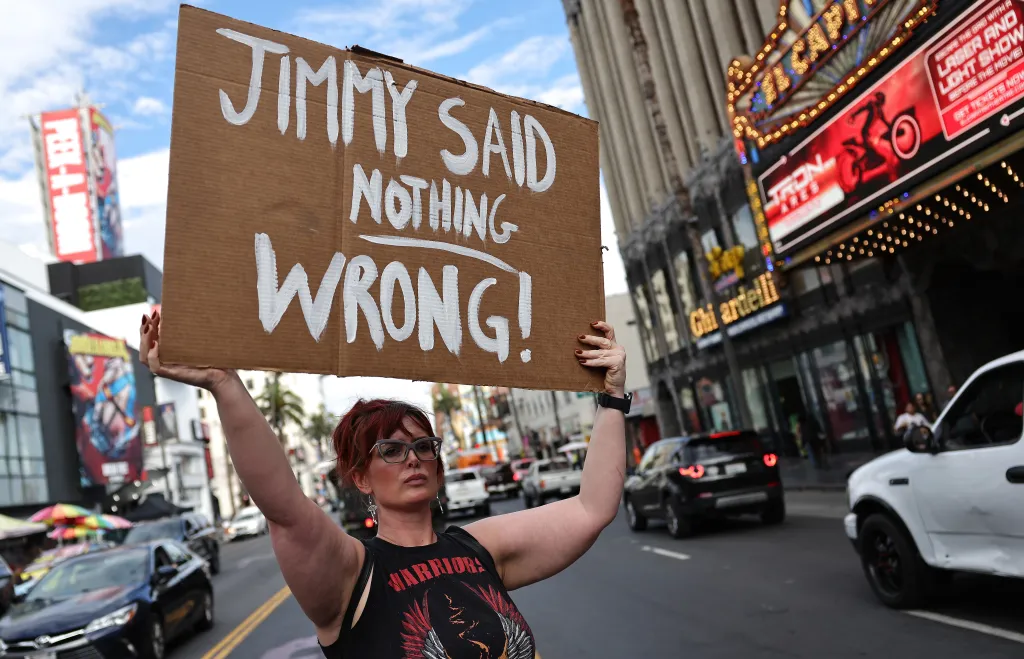 A demonstrator holding a sign that reads 