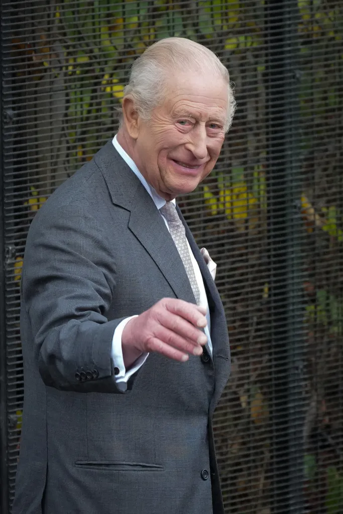 King Charles III waves to the public while visiting a synagogue in Manchester, England.