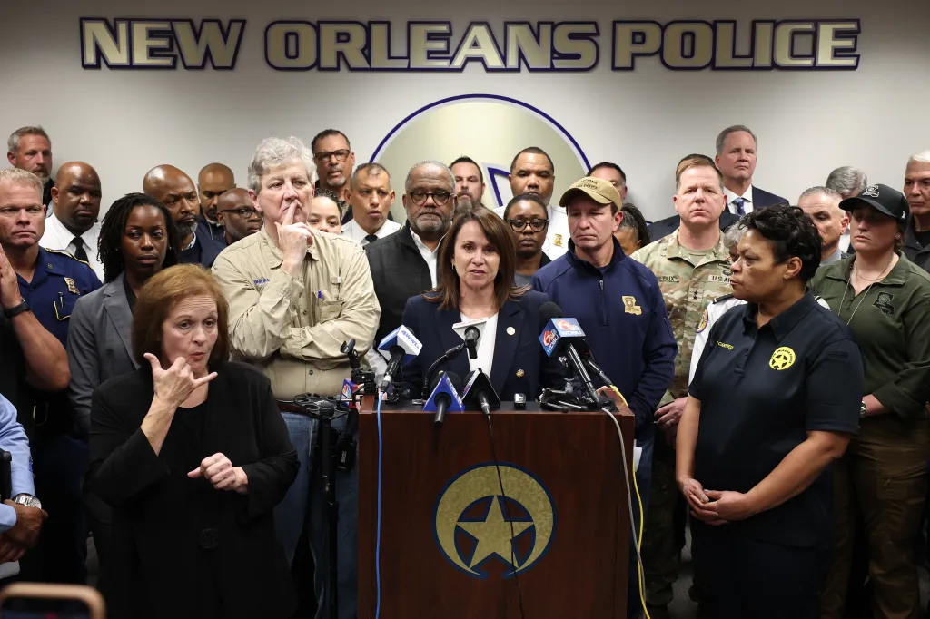 Louisiana Attorney General Liz Murrill speaks at a press conference about the New Orleans Bourbon Street incident, with an ASL interpreter and other officials present.