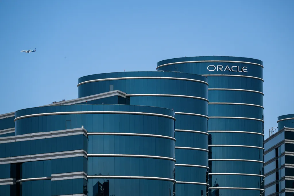 The Oracle offices in Redwood City, California, with the company logo visible on one of the blue glass buildings.