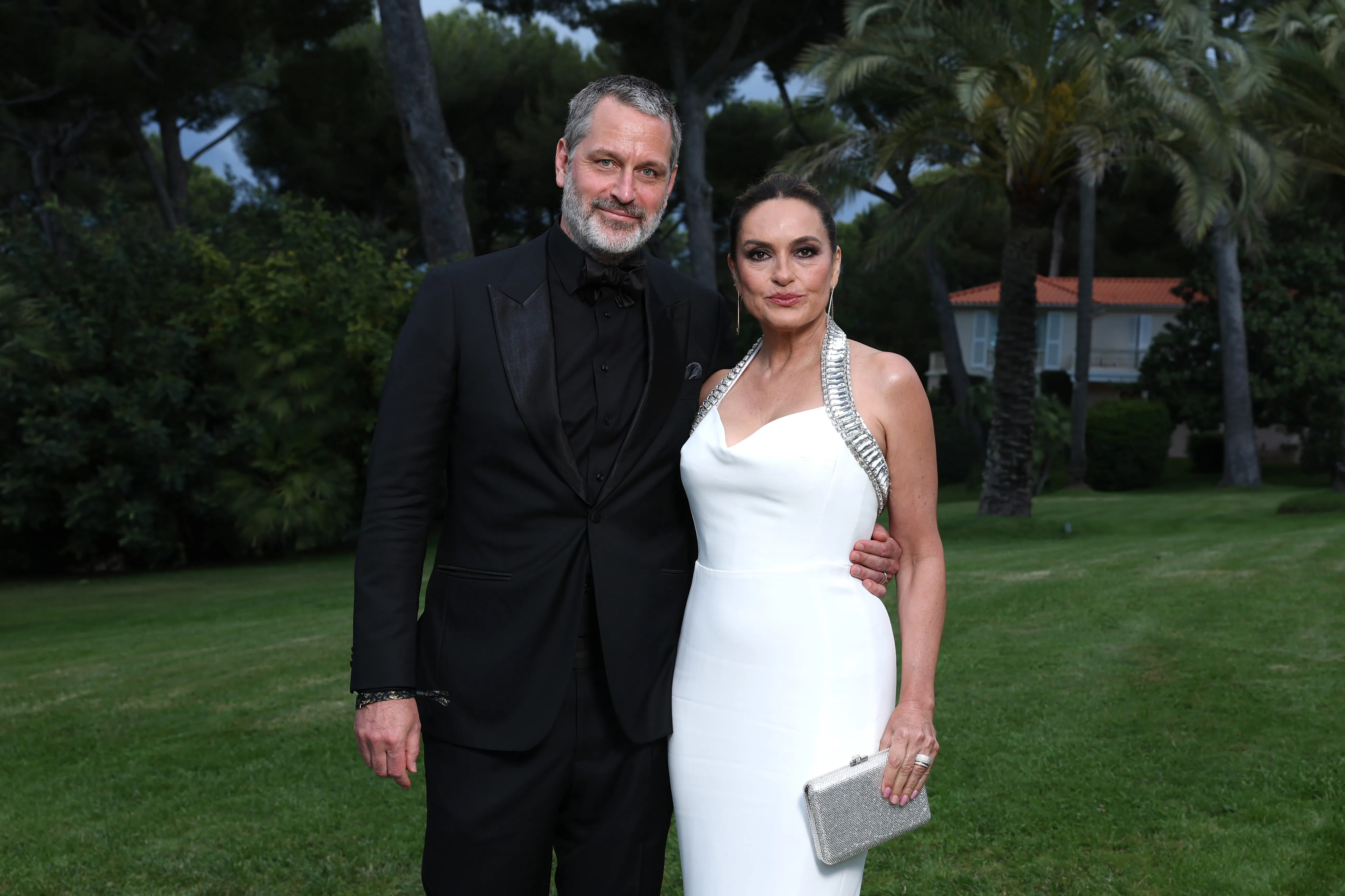 Peter Hermann and Mariska Hargitay posing outdoors.
