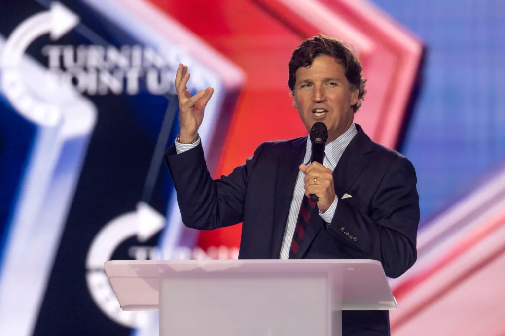 Tucker Carlson speaking at AmericaFest 2025 Day One.