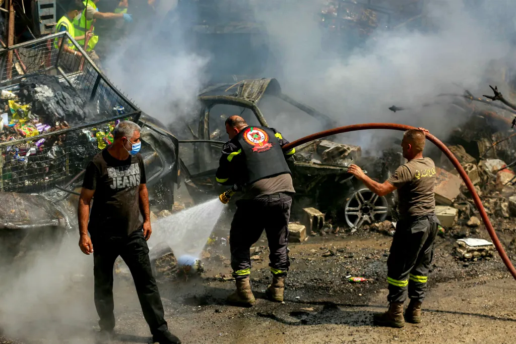 Civil defence members extinguish a fire in the village of Saksakiyeh in southern Lebanon.