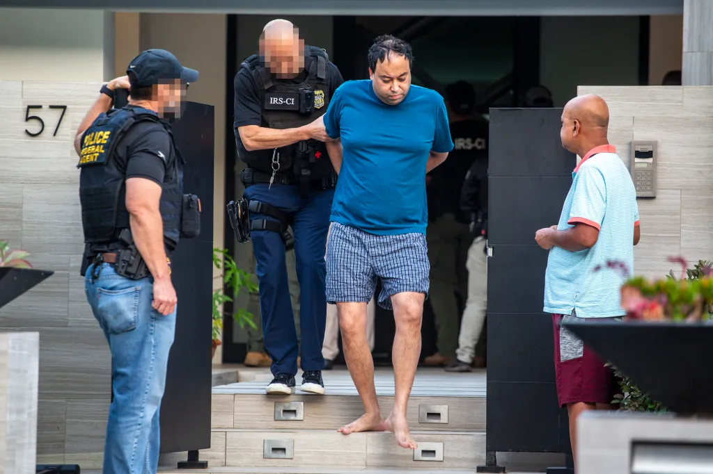 Federal authorities detaining a man suspected of a $100 million loan-fraud scheme.