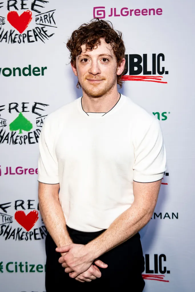 Ethan Slater, in a white T-shirt and black pants, at the opening night of 