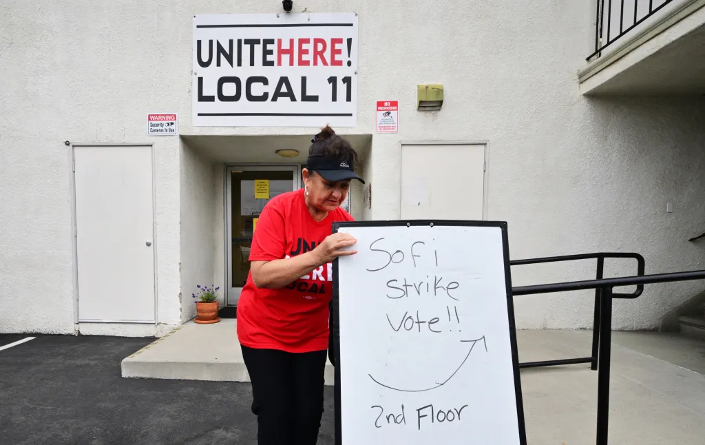 Yolanda Fierro positions a sign for the SoFi Strike Vote at the UNITE HERE Local 11 union office.