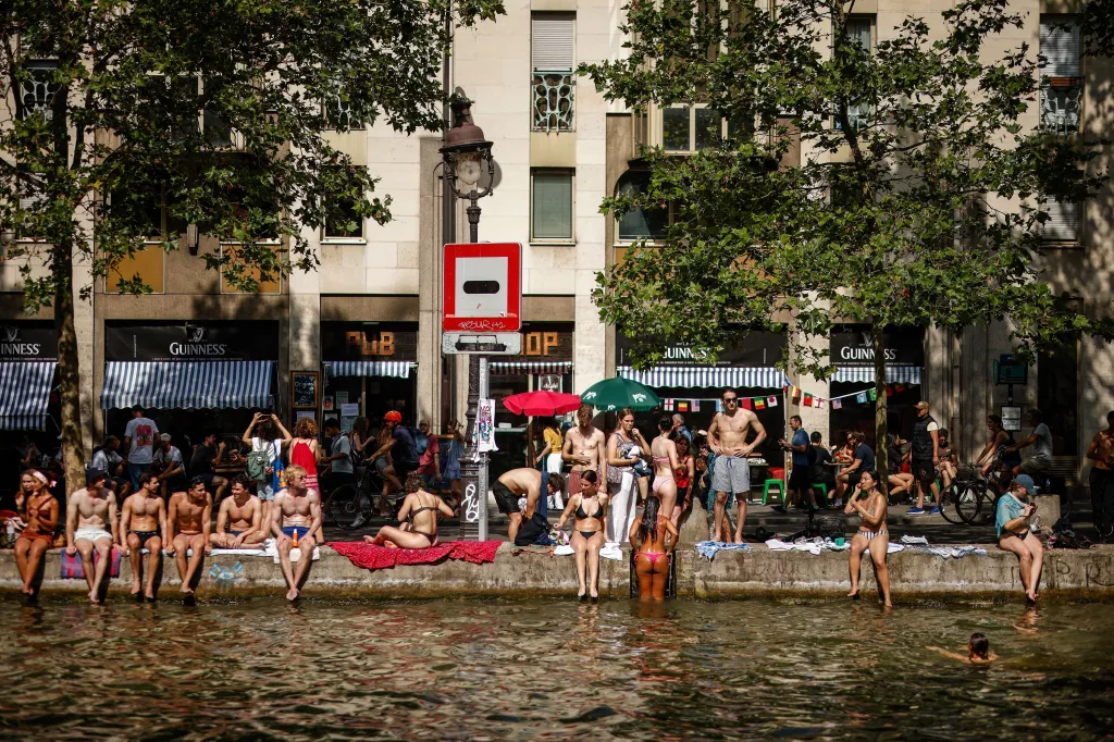 People cool off in the Canal Saint-Martin during a heatwave in Paris, France.