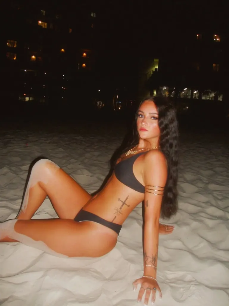 Marly Kinney, a missing teen, posing on a beach at night.
