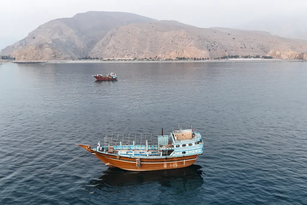 Aerial view of two boats anchored in the water off Oman's Musandam Peninsula near the Strait of Hormuz.
